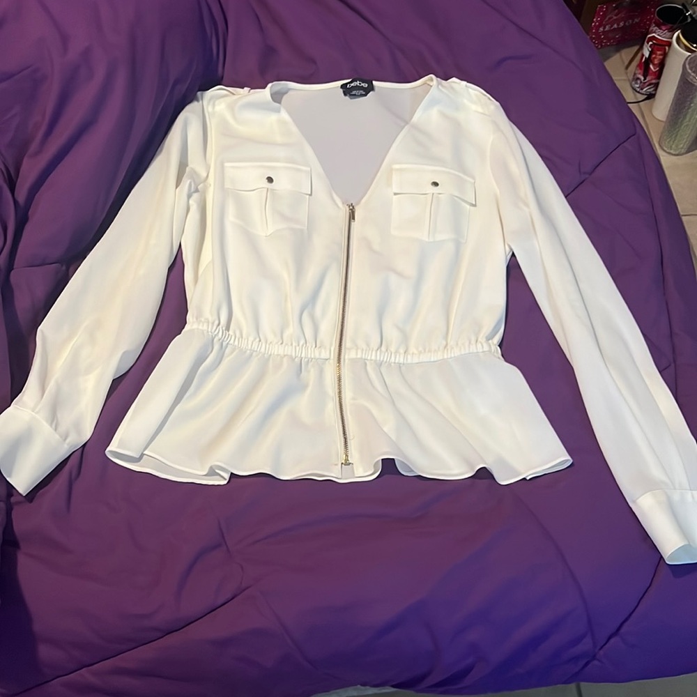 White long sleeve dressy zip up top, with buttons on the sleeves.